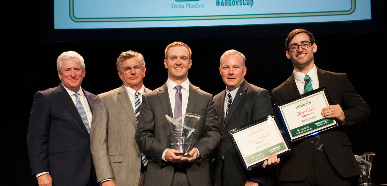 Ouachita students Chandler Blake (center) and Chris Clark (far right) win second place in the undergraduate division at the Arkansas Governor’s Cup Business Plan Competition for their business plan, WinterTerm.com. They are joined, from left, by Rush Deacon, president of Arkansas Capital Corporation; Dhu Thompson, president of Delta Plastics; and Arkansas Lt. Gov. Tim Griffin.