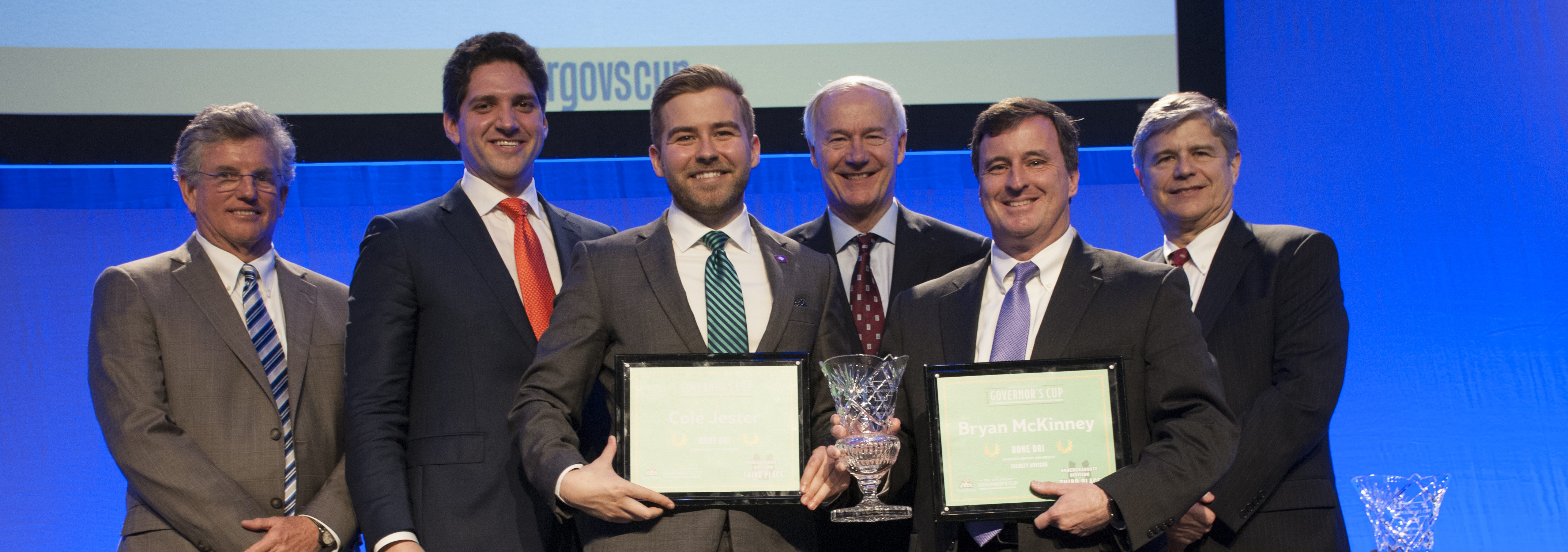 At the recent Governor’s Cup Business Plan Competition, Ouachita’s Cole Jester (third from left) and his faculty advisor, Bryan McKinney (fifth from left), won third place in the undergraduate division and first place for undergraduate elevator pitch for Jester’s business plan, Bone Dri. The awards were presented by (from left) Dhu Thompson, owner and president of Delta Plastics; William Rockefeller, Winrock Automotive; Arkansas Governor Asa Hutchinson; and Kevin Burns, Stephens, Inc.