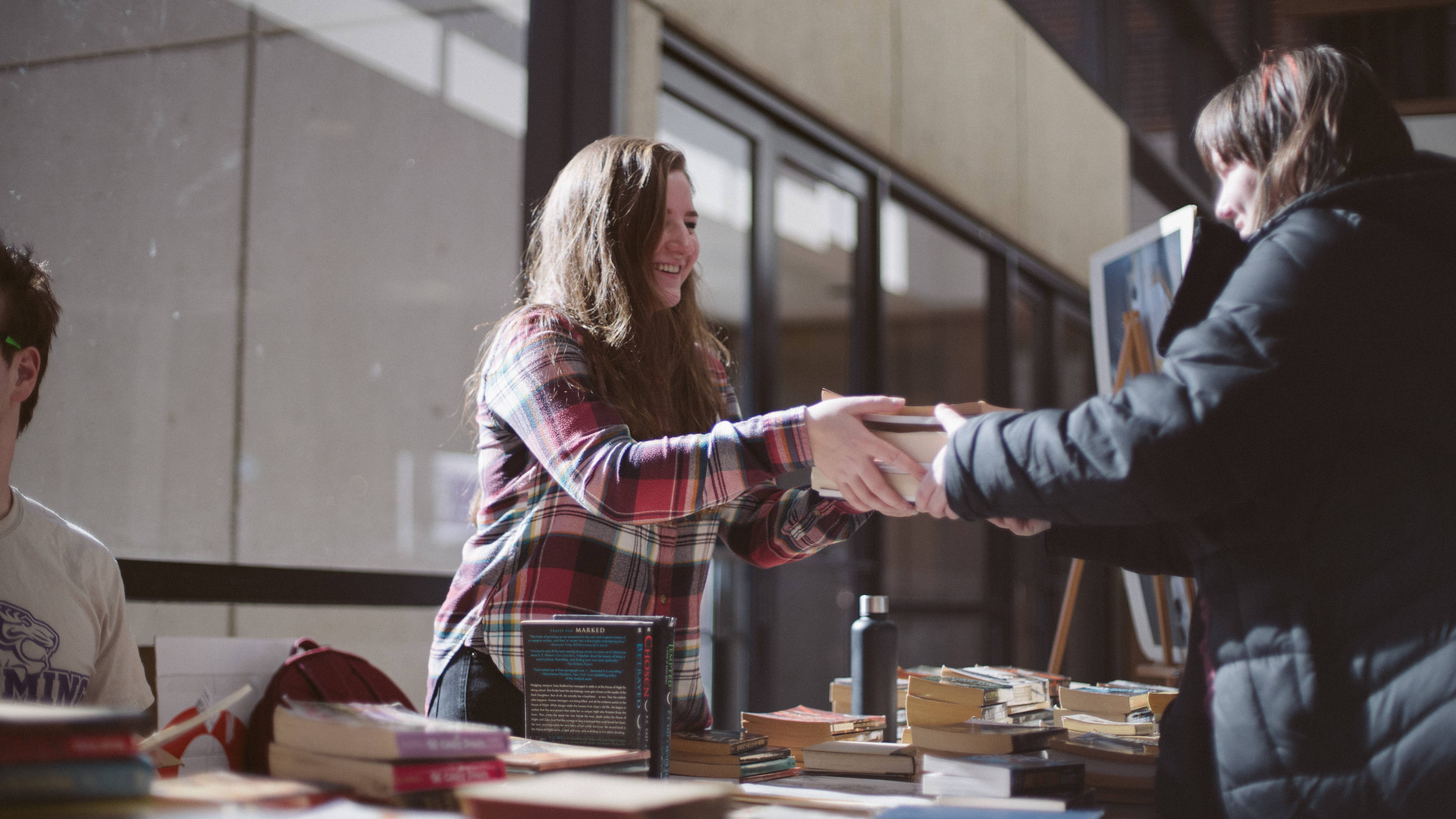 Student purchases book from book sale