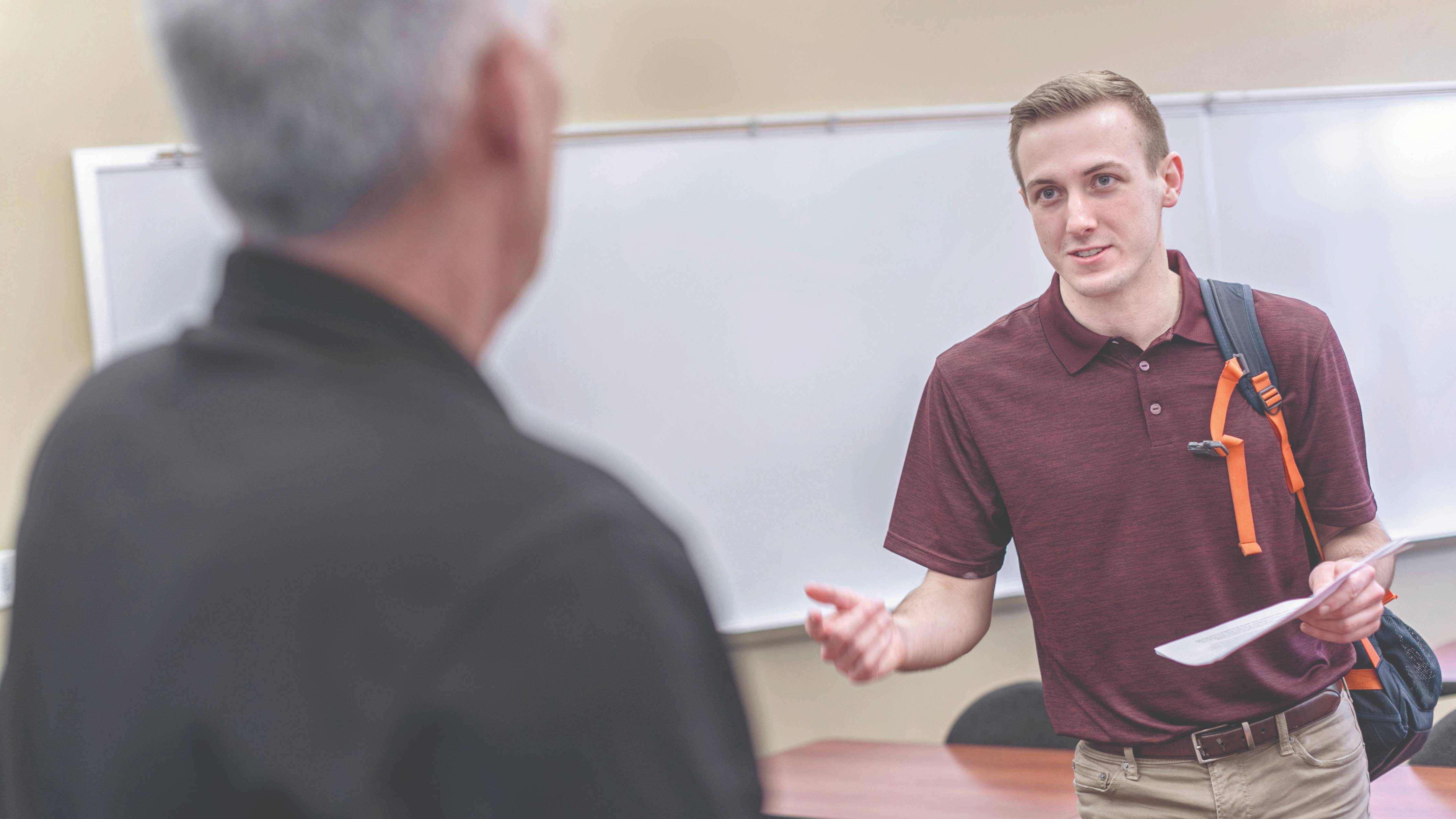 Faculty and student talking